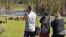 Visitors take pictures of a bison herd in the Hayden Valley in Yellowstone National Park, Wyoming, June 22, 2022.