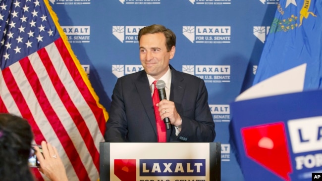 Nevada Republican US Senate candidate Adam Laxalt celebrates his victory with family, friends and supporters at the Tamarack Casino in Reno, Nev., June 14, 2022. (