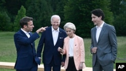 From left, President Emmanuel Macron, US President Joe Biden, European Commission President Ursula von der Leyen and Canada's Prime Minister Justin Trudeau leave after posing for a group photo , during the G7 Summit, at Castle Elmau in Kruen, near Garmisc