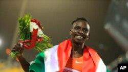 FILE - Francine Niyonsaba of Burundi celebrates winning the woman's 3000 meters at the Qatar Diamond League athletics meet in Doha, Qatar, Friday, May 13, 2022.