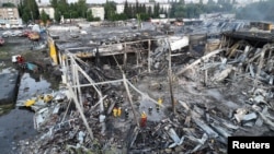 Rescuers work at a site of a shopping mall hit by a Russian missile strike, as Russia's attack on Ukraine continues, in Kremenchuk, in Poltava region, Ukraine, in this picture released 6.28.2022 by the State Emergency Service of Ukraine.