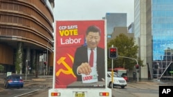 FILE: A truck sponsored by conservative lobby group Advance Australia displaying an image of Chinese President Xi Jinping casting a vote for the Australian opposition Labor Party drives down a local street, April 9, 2022, in the Parramatta area of Sydney.