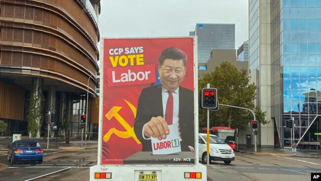 FILE: A truck sponsored by conservative lobby group Advance Australia displaying an image of Chinese President Xi Jinping casting a vote for the Australian opposition Labor Party drives down a local street, April 9, 2022, in the Parramatta area of Sydney.