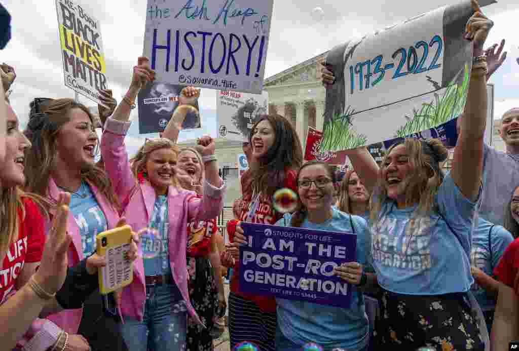 Anti-abortion protesters celebrate following the Supreme Court's decision to overturn Roe v. Wade, federally protected right to abortion, outside the Supreme Court in Washington.