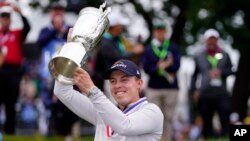 Matthew Fitzpatrick of England celebrates with the trophy after winning the U.S. Open golf tournament at The Country Club, June 19, 2022, in Brookline, Massachusetts. 