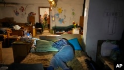 A man sleeps as he hides from Russian shelling in a basement in Lysychansk, Luhansk region, Ukraine, June 16, 2022.