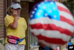 A woman wipes tears after a mass shooting at the Highland Park Fourth of July parade in Highland Park, Ill., a Chicago suburb, July 4, 2022.