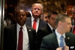 President-elect Donald Trump gets on an elevator after speaking with reporters at Trump Tower in New York, Jan. 9, 2017. Trump has dismissed the dossier as "fake news," created by his political opponents.