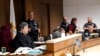 Lake County Judge Theodore Potkonjak, left, looks at a video screen as he presides over the initial appearance of Robert E. Crimo III at the county courthouse, July 6, 2022, in Waukegan, Ill. 