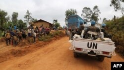 FILE — Moroccan soldiers from the UN mission in DRC, Monusco, ride in a vehicle as they patrol in the violence-torn Djugu territory, Ituri province, eastern DRCongo, March 13, 2020.