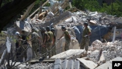 Ukrainian State Emergency Service firefighters work at a damaged residential building in the town of Serhiivka, about 50 kilometers southwest of Odesa, Ukraine, July 1, 2022.