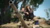 A Ukrainian soldier flashes the victory sign atop a tank in Donetsk region, Ukraine, June 20, 2022. 