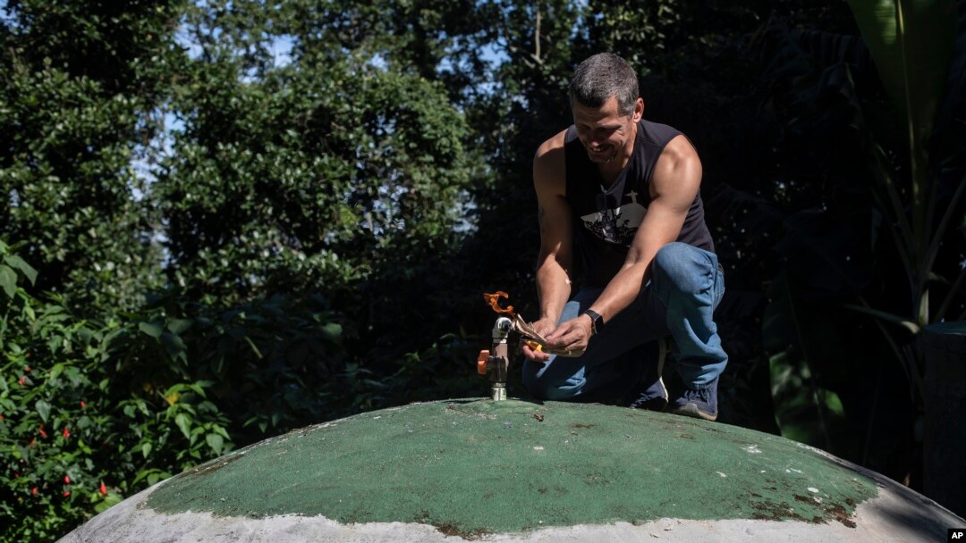 Residents' association President Otavio Barros works on the gas outlet of the sewage treatment biosystem of the Enchanted Valley sustainable community on the outskirts of Tijuca National Forest in Rio de Janeiro, Brazil, June 6, 2022.