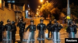 Agentes de la policía antidisturbios montan guardia durante una protesta antigubernamental en medio de un punto muerto entre el gobierno del presidente Guillermo Lasso y manifestantes mayoritariamente indígenas que exigen el fin de las medidas de emergencia, en Quito, Ecuador, el 23 de junio de 2022. REUTERS/Santiago Arcos