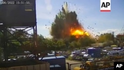 This image taken from video and provided by the Ukrainian Presidential Press Office , June 28, 2022, claims to show the moment just after a missile struck a shopping mall in Kremenchuk, Ukraine.