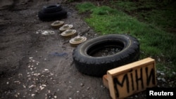 FI:LE - A sign reads 'Mines' next to anti-tank mines, amid Russia's attack on Ukraine, in the village of Husarivka, in Kharkiv region, Ukraine, Apr. 14, 2022.