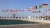 The 2022 World Cup countdown clock and national flags are seen in Doha, Qatar, June 16, 2022.