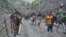 An Indian security guard keeps vigil as pilgrims cross mountain trails during their journey to the holy Amarnath cave in India. (Photo by Wasim Nabi)