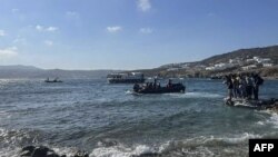 This handout picture released by the Greek Coast Guard on June 19, 2022, shows rescued migrants during their transfer to Mykonos Island.