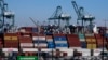 Cargo containers sit stacked at the Port of Los Angeles, on Oct. 20, 2021, in San Pedro, Calif. Dockworkers and shipping companies at 29 ports on the U.S. West Coast say they plan to keep cargo moving as they negotiate a contract. The last one expired Friday.