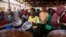 FILE - Refugees from the Democratic Republic of Congo (DRC) receive lunch at the Nyakabande Transit Center in Kisoro, Uganda, June 7, 2022, following deadly fights between M23 rebels and DRC troops.