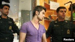 FILE - Morality police detain a man with unacceptable hair and clothing styles during a crackdown on "social corruption" in north Tehran, June 18, 2008. State media said on June 19, 2022, that 120 people had been arrested in Mazandaran province on morality charges.