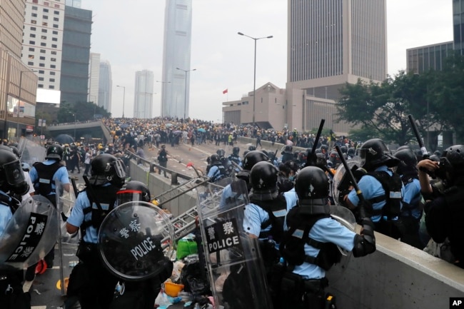 FILE - Riot police gather face off with demonstrators near the Legislative Council in Hong Kong on June 12, 2019. (AP Photo/Kin Cheung, File)