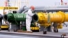 FILE - An inspection officer checks a tanker carrying imported crude oil at Qingdao port in China's eastern Shandong province, May 9, 2022.