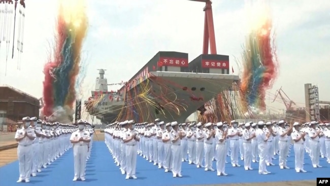 This screen grab made from video released by Chinese state broadcaster CCTV shows the launch ceremony of the Fujian, a People's Liberation Army (PLA) aircraft carrier, at a shipyard in Shanghai on June 17, 2022.