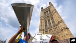A protester shouts outside parliament, in London, July 11, 2022. Eleven people have announced their candidacy to replace Boris Johnson as leader of the ruling Conservative Party and Britain's prime minister.