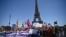 FILE - Demonstrators hold a banner reading "abortion is a basic right" in front of the Eiffel Tower as they take part in a rally calling for right to abortion to be protected by Constitution in Paris, July 2, 2022.