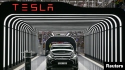 FILE: Model Y cars are shown during the opening ceremony of the new Tesla Gigafactory for electric cars in Gruenheide, Germany, March 22, 2022. 