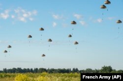 Soldiers taking part in the airborne operation named Operation Thunder Lynx jump over Estonina territory as part of NATO missions in Estonia, June 22, 2022.