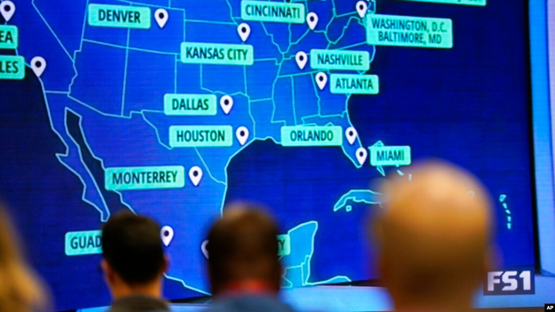 People wait and watch before FIFA announces the 2026 World Cup host cities, June 16, 2022, in Atlanta.