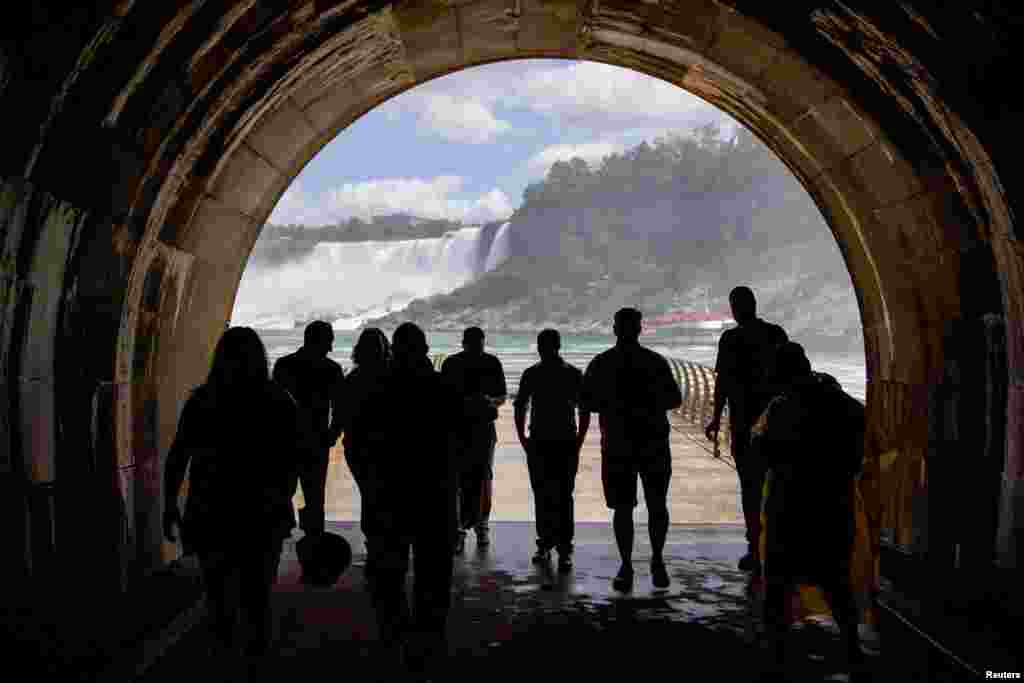 People make their way through the tunnel after a ceremony ahead of the opening of the century-old Tunnel as a new tourist attraction at at the Niagara Parks Power Station in Niagara Falls, Ontario, Canada, June 28, 2022. 