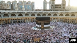 Muslim worshippers gather before the Kaaba at the Grand Mosque in Saudi Arabia's holy city of Mecca, Saudi Arabia, July 2, 2022. 