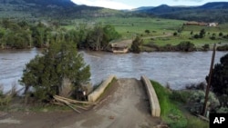 A washed out bridge shown along the Yellowstone River Wednesday, June 15, 2022, near Gardiner, Mont. (AP Photo/Rick Bowmer)