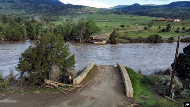A washed out bridge shown along the Yellowstone River Wednesday, June 15, 2022, near Gardiner, Mont. (AP Photo/Rick Bowmer)