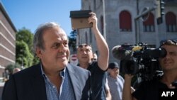Former UEFA president Michel Platini surrounded by journalists, arrives to Switzerland's Federal Criminal Court to listen the verdict of his trial over a suspected fraudulent payment, in the southern Switzerland city of Bellinzona, on July 8, 2022.