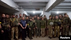 Ukraine's President Volodymyr Zelenskiy poses for a picture with Ukrainian service members, as Russia's attack on Ukraine continues, at a position in unknown location in Southern Ukraine, June 18, 2022. (Ukrainian Presidential Press Service/Handout via Re