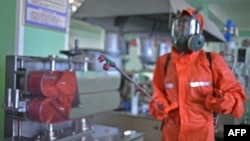 지난 6월 북한 평양의 한 공장에서 신종 코로나바이러스 방역을 위한 소독약을 뿌리고 있다.