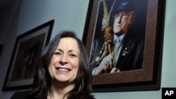 FILE - Marilynn "Lynn" Malerba stands next to a photograph of late Chief Ralph Sturges at Tribal offices in Uncasville, Connecticut, on March 4, 2010. Malerba, who is Native American, was nominated by President Joe Bident to be U.S. Treasurer, Tuesday, June 21, 2022.