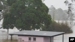 A building is inundated with water at Richmond on the outskirts of Sydney, Australia, on July 5, 2022. Hundreds of homes have been inundated in and around Australia’s largest city in a flood emergency that was threatening 50,000 people, officials said.