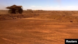 FILE - An autonomous vehicle drives along a road as it collects iron ore at Australia's Fortescue Metals Group mine in the Pilbara region, located south-east of the coastal town of Port Hedland in Western Australia, Nov. 29, 2018. 