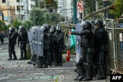 Police confront demonstrators during clashes in the El Arbolito park area in Quito, June 22, 2022, on the 10th consecutive day of Indigenous-led protests against the Ecuadorean government.
