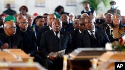 South African President Cyril Ramaphosa, center, attends a funeral in Scenery Park, East London, South Africa, July 6, 2022. More than a thousand mourners attended services for 21 teenagers who died in a mysterious tragedy at a nightclub nearly two weeks ago.