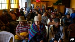 Magdalena Tepaz, center, and Manuel de Jesus Tulul, right, parents of Wilmer Tulul, wait for the start of a community meeting in Tzucubal, Guatemala, June 29, 2022. Wilmer and his cousin Pascual, both 13, were among the dead discovered inside a semitrailer on the edge of San Antonio, Texas, June 27.