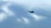 In this image taken from video, a fighter jet flies overhead and visible from Tak province, Thailand on Thursday, June 30, 2022.