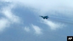 In this image taken from video, a fighter jet flies overhead and visible from Tak province, Thailand on Thursday, June 30, 2022.