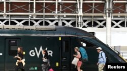 Sejumlah penumpang bersiap menaiki kereta api yang akan berangkat menuju wilayat barat Inggris di Stasiun Paddington, London, pada 20 Juni 2022. Rencana mogok kerja yang dilakukan pekerja kereta api kemungkinan besar akan berlangsung pada pekan ini. (Foto: Reuters/Toby Melville)